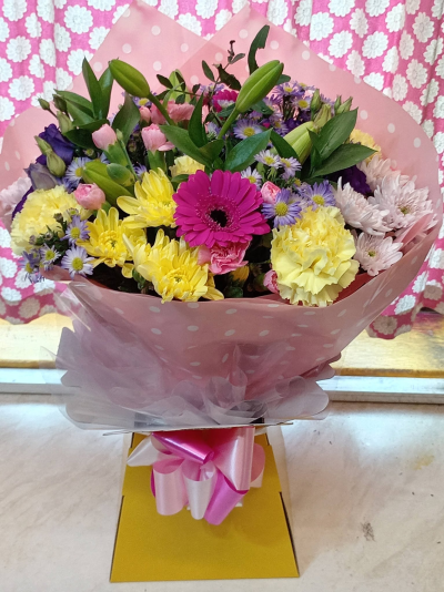 Lemon Sorbet - A cheerful bouquet combining sunny yellow, vibrant pink and soft purple tones with fresh greenery for a bright, playful finish.