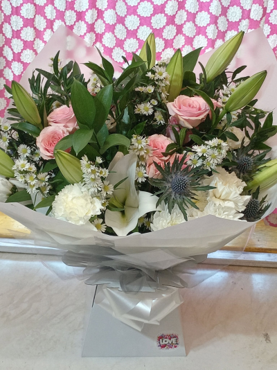 Rose & Pearl - An elegant bouquet in soft pink and crisp white tones, beautifully balanced with rich greenery for a fresh, graceful finish.