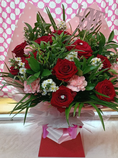 Love Always - A luxurious romantic bouquet in rich red and soft pink tones, finished with lush greenery and an elegant love-themed touch.